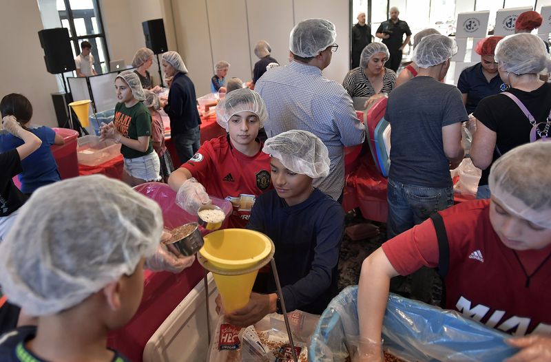 Bar Mitzvah Project Involves Packing Meals for People In Need